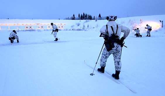 Soldiers on the shooting range skis on foot