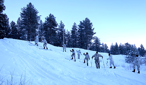 Soldiers are skiing up the hill