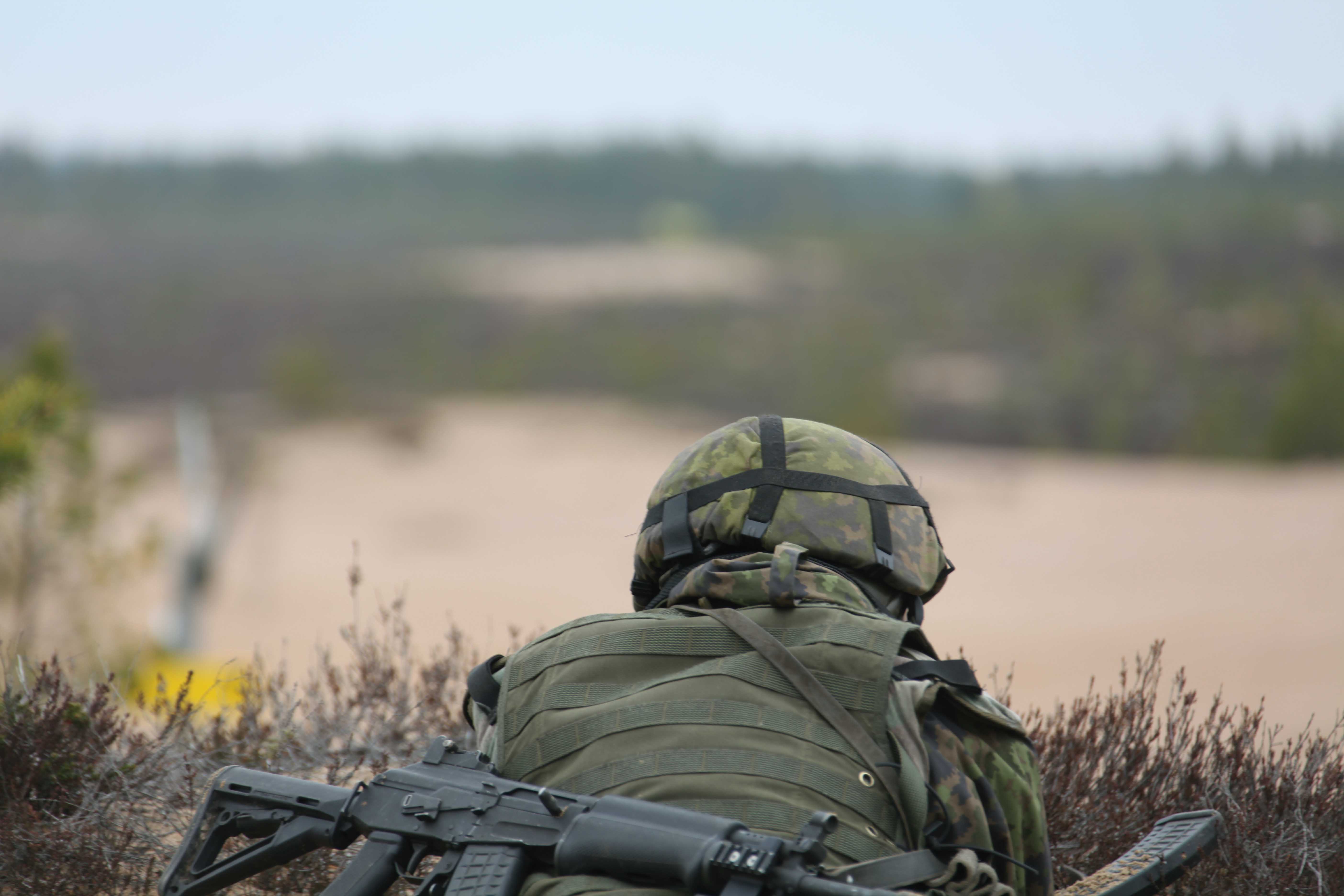 Soldier laying down on a hill