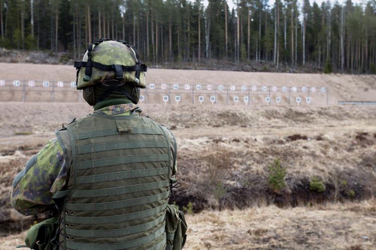 The soldier looks at the targets on the shooting range.