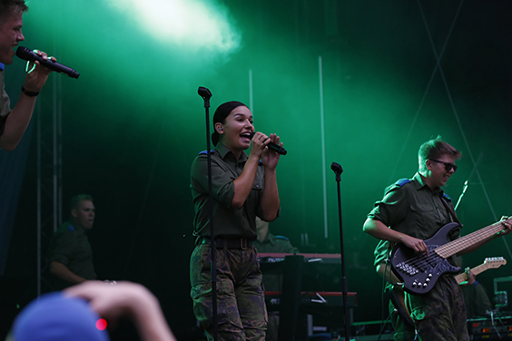 A conscript band plays and sings on stage