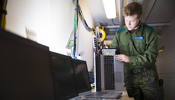 Conscript repairing a laptop