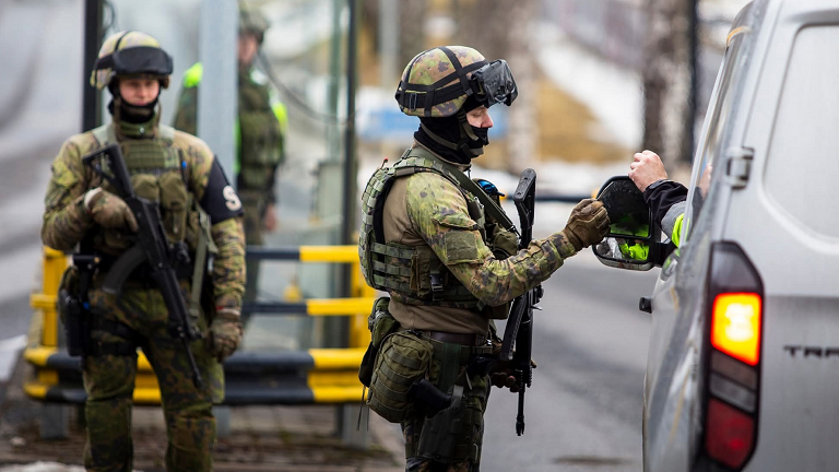 Two soldiers next to a van 